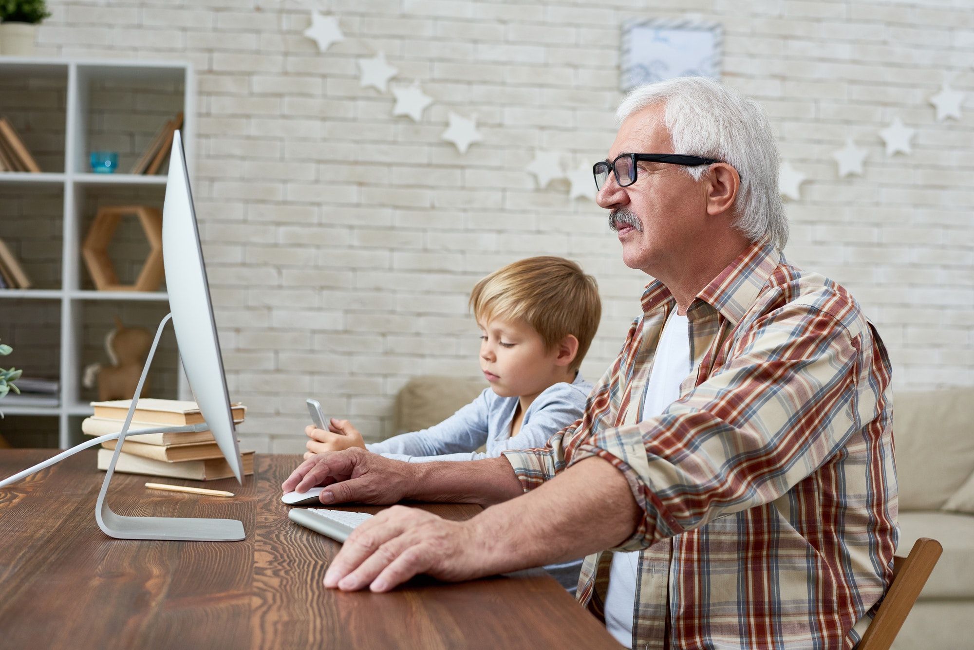 Grandfather and Little Boy Using PC